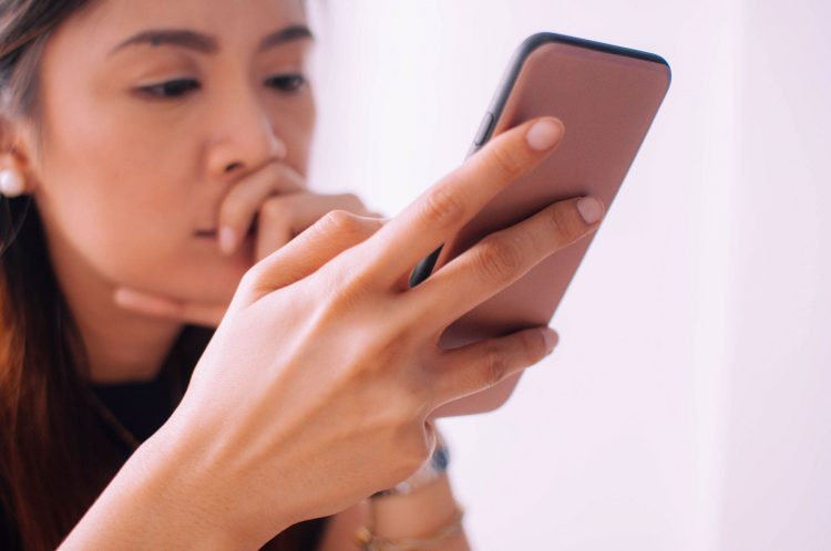 woman looking at phone ebay-suspension