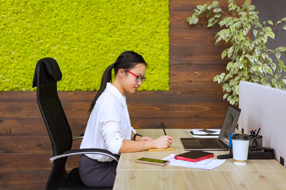 woman working on a project in her cubicle