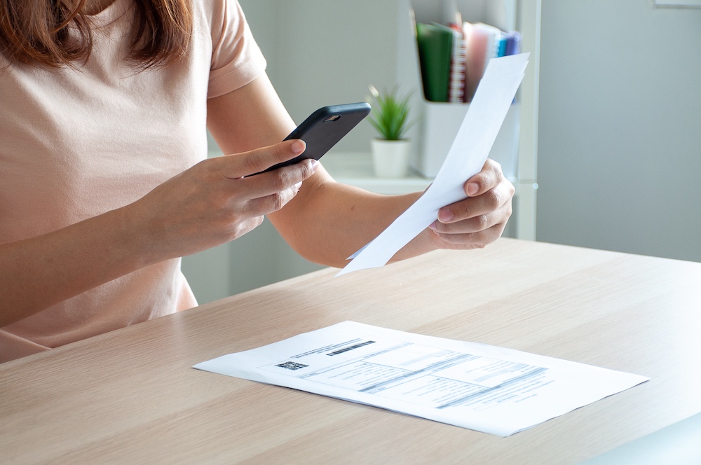 Woman scanning receipt using her phone